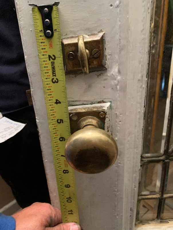 Measuring an antique mortise lockset before replacement